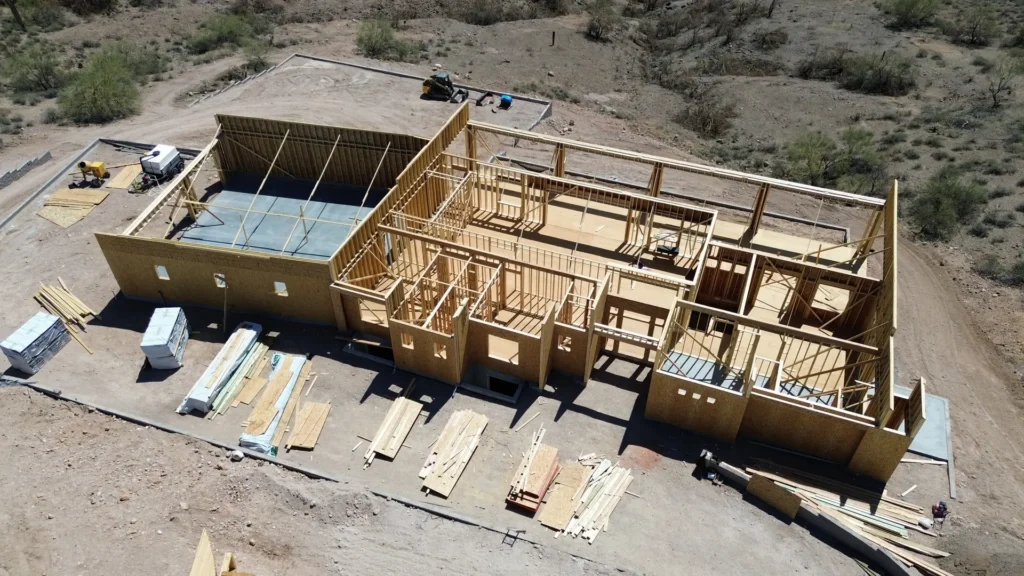 Wood framing phase of a new home construction project in Mesa, AZ by Cowboy's General Construction viewed from above.